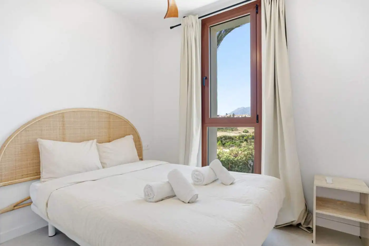 Bright bedroom featuring a large window with scenic views in Cancelada, Estepona. Perfect for relaxi.
