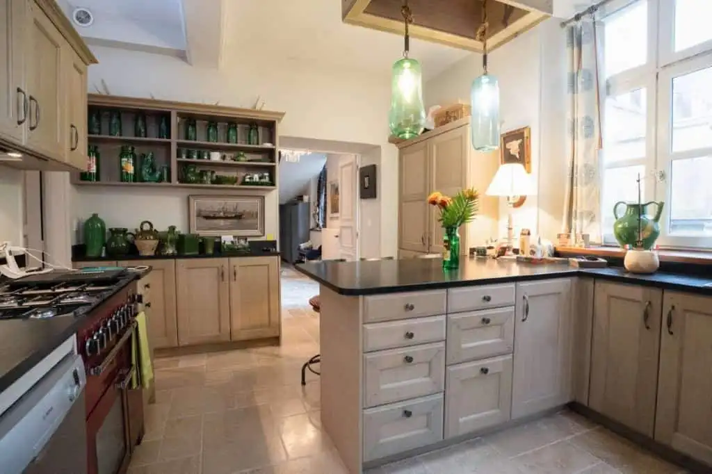 Charming kitchen of a 5-bedroom house for sale in Chateaudun, France, featuring modern appliances an.