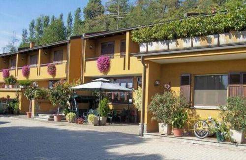 Hotel on Lake Viverone with charming exterior and lush greenery, ideal for investment or hospitality.