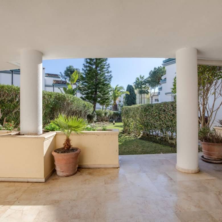 Beachfront view from a luxury property in Dominion Beach with lush gardens and modern architecture.