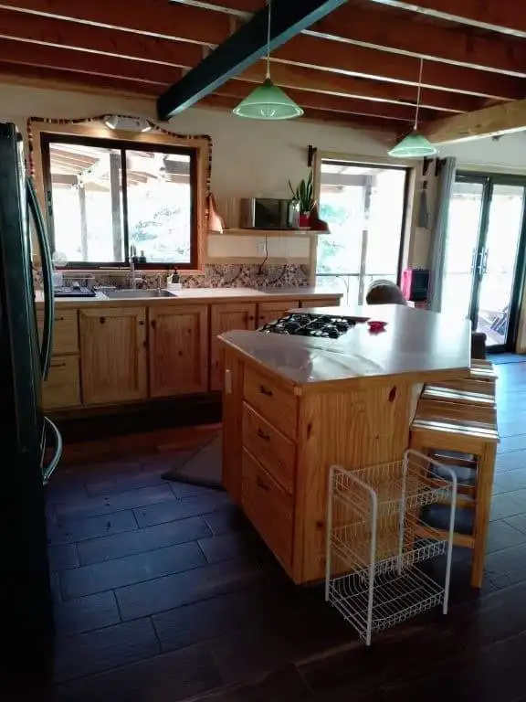 Kitchen with wooden cabinets and island in Rio Blanco, Costa Rica.