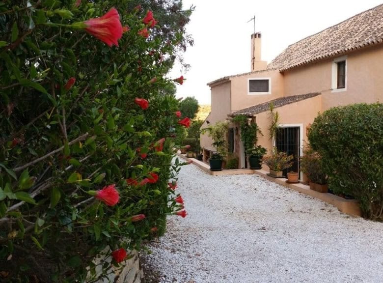 Beautiful view of a traditional Spanish finca with lush greenery in Estepona, Spain.