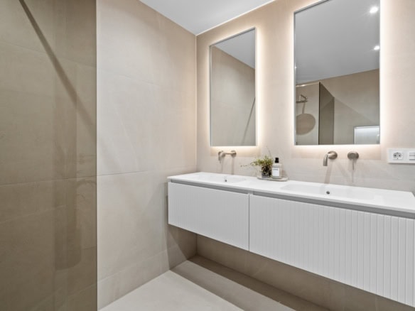 Modern bathroom with double sink vanity and large mirrors in a stylish apartment in Costa del Sol, S.