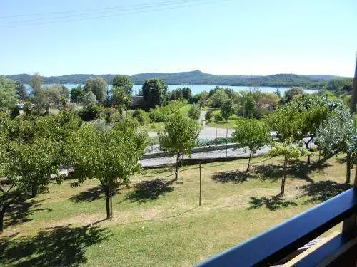 Hotel overlooking Lake Viverone with lush greenery and scenic lake views in Piverone, Italy.
