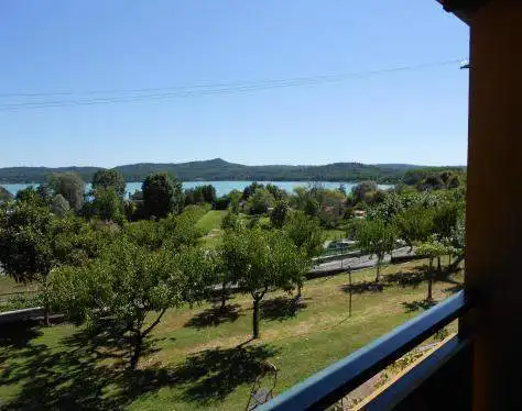 Hotel with scenic lake and green landscape view in Piverone, Italy.