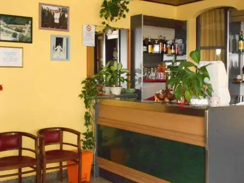 Hotel reception area with plants and decor, located near Lake Viverone in Piverone, Torino, Italy.