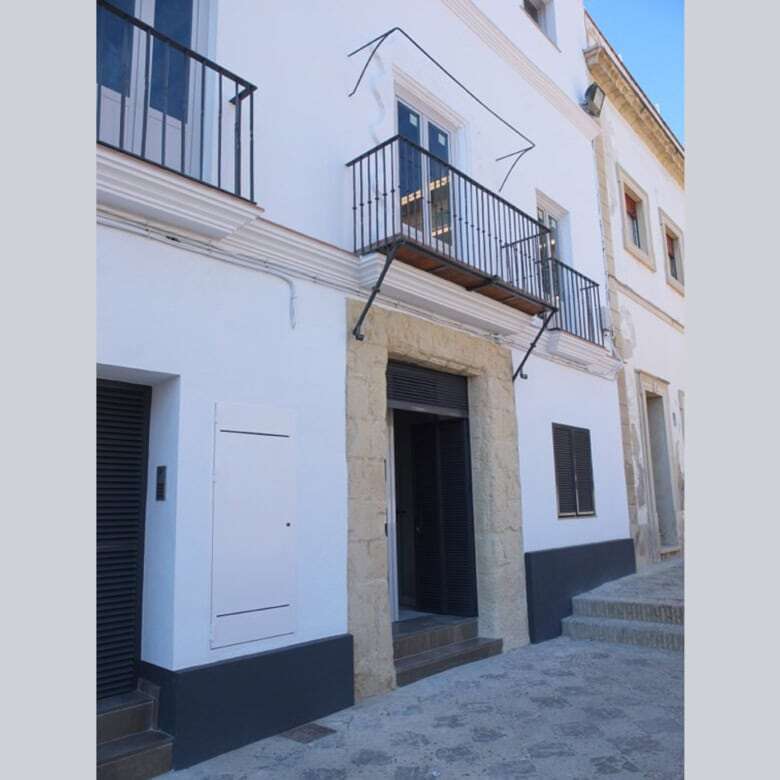 White apartment building with balconies in El Puerto de Santa María, Cadiz.