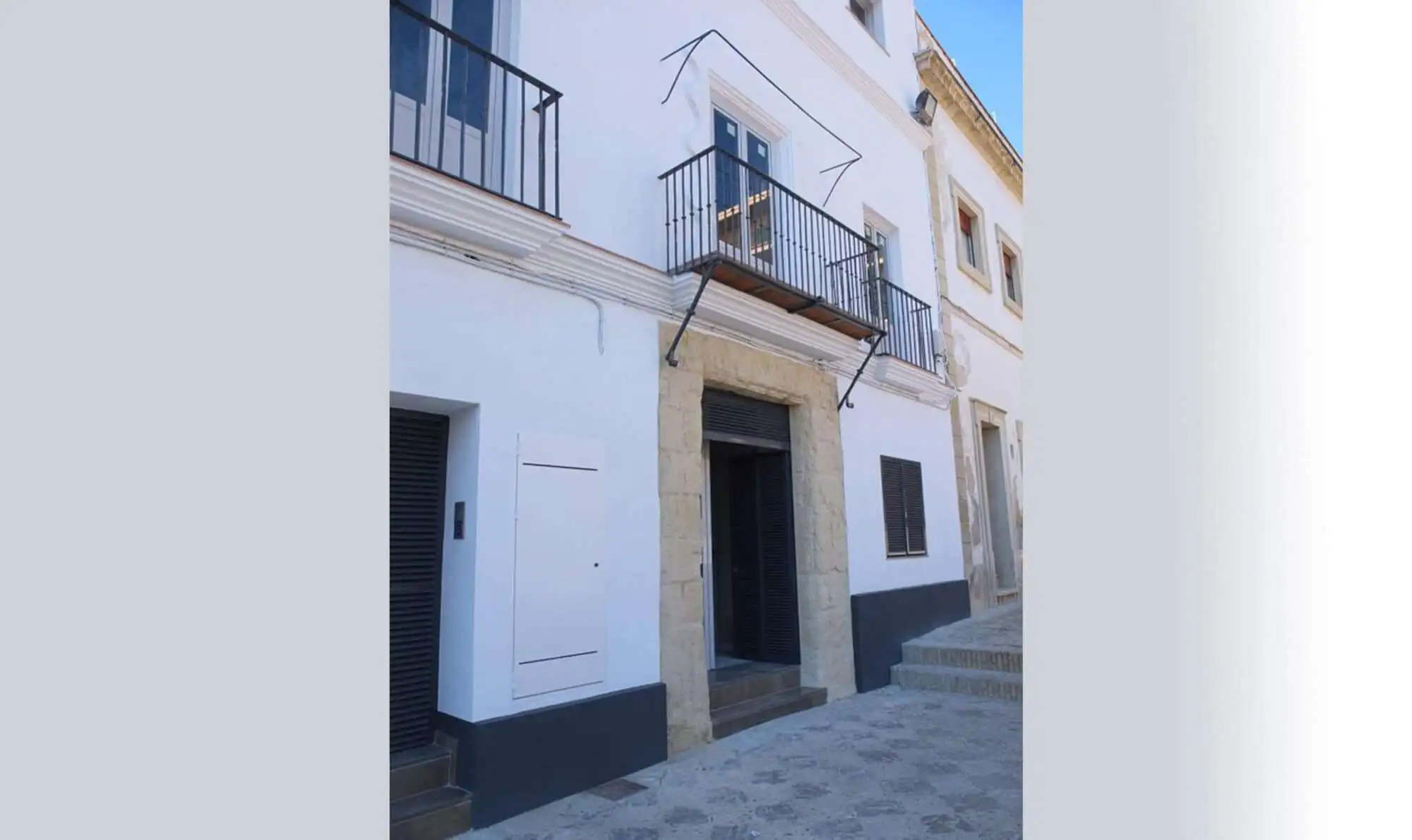 White apartment building with balconies in El Puerto de Santa María, Cadiz.