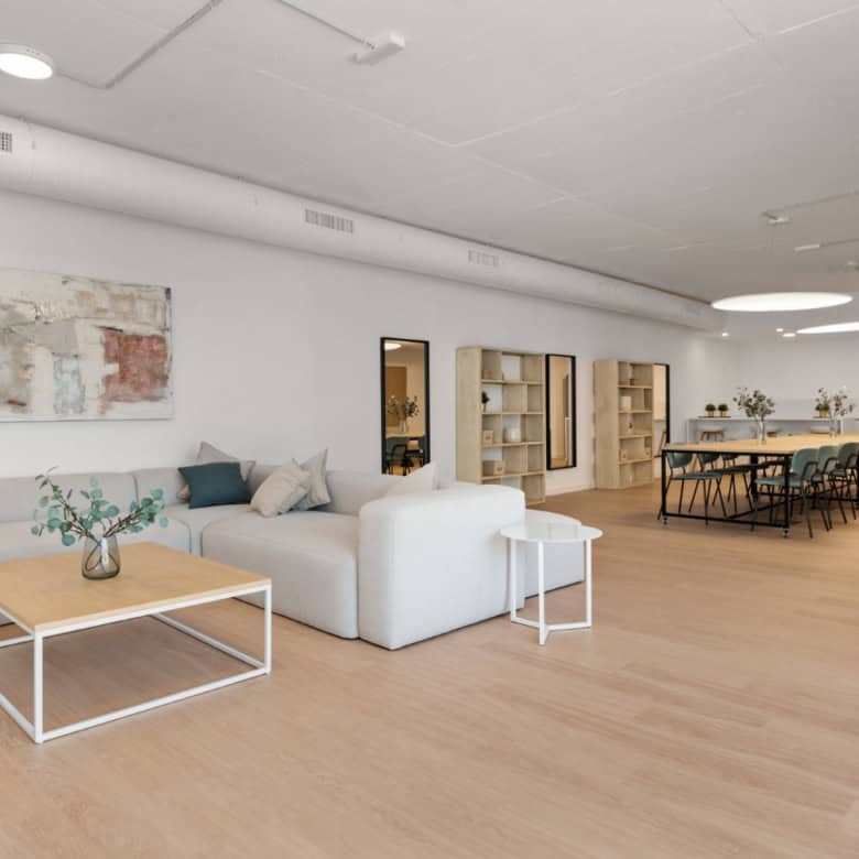 Spacious modern living room with white sofa, wooden flooring, and minimalist decor in Selwo Estepona.