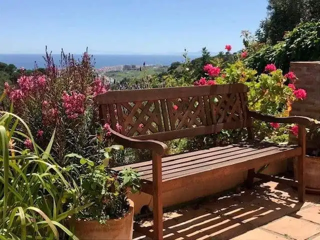 Beautiful garden with colorful flowers and scenic sea view in Estepona, Spain.