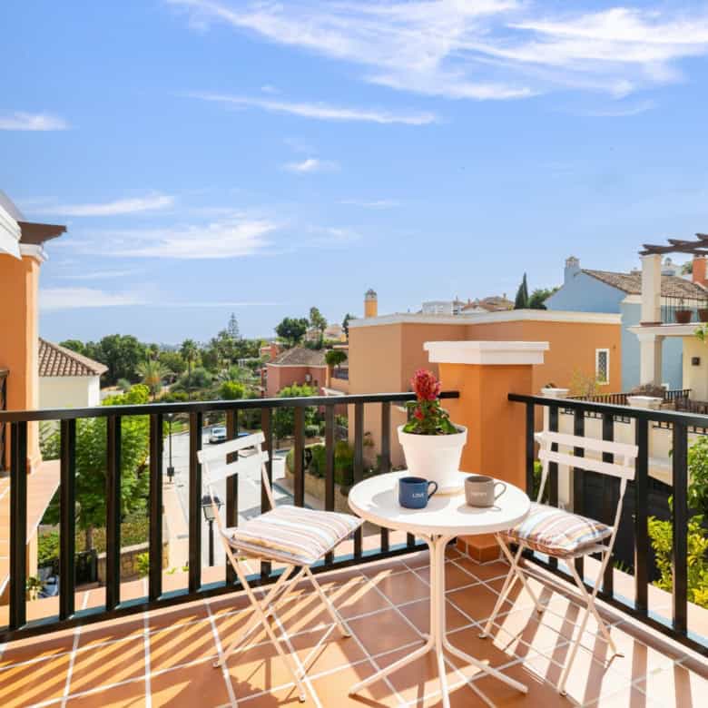 Balcony view of a refurbished townhouse in Brisas del Sur, Nueva Andalucía, with outdoor seating and.