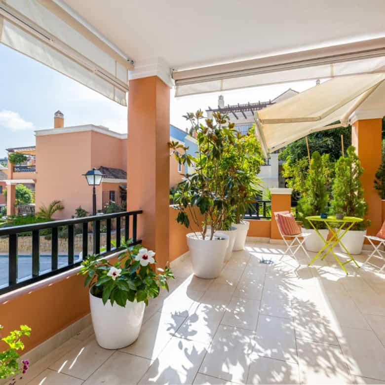 Balcony of a refurbished townhouse in Brisas del Sur, Nueva Andalucía, featuring outdoor seating and.