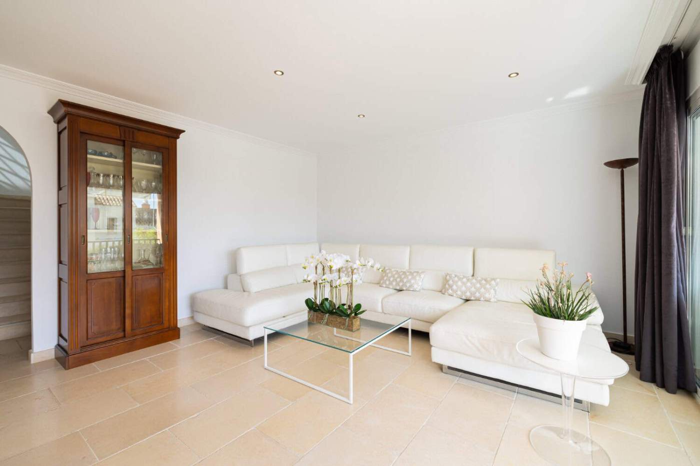 Refurbished Townhouse Interior Modern living room with white sofa and glass coffee table.