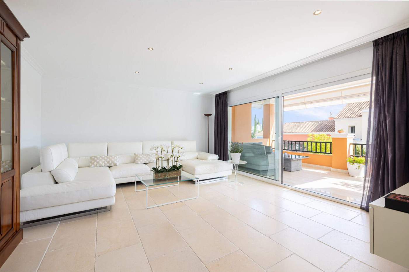 Refurbished Townhouse Living Room Modern living room with bright, spacious design and large sliding glass doors opening to a sunny ter.