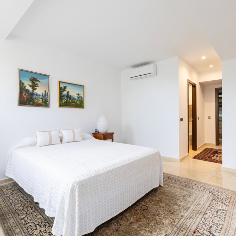 Modern bedroom in Brisas del Sur townhouse with stylish decor and comfortable furnishings.