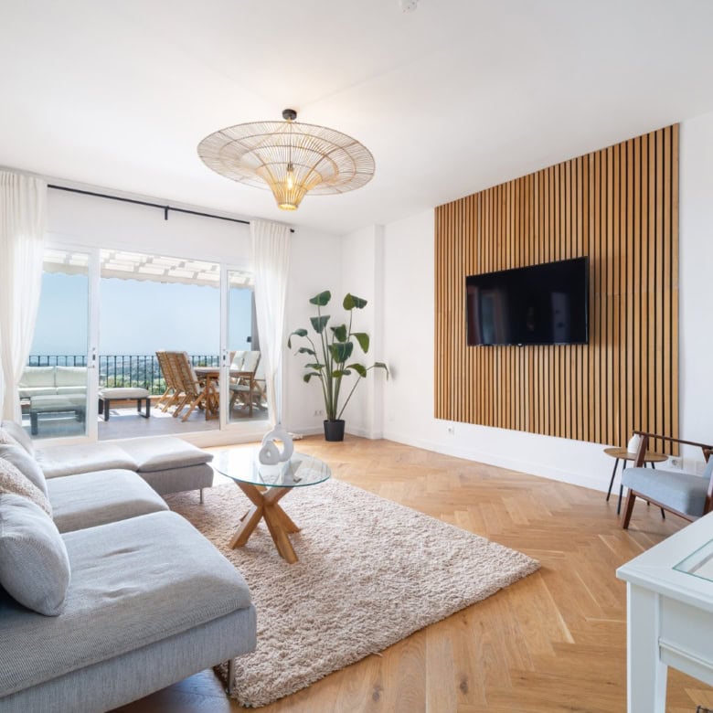 Luxurious penthouse interior with modern decor and panoramic south-facing windows.