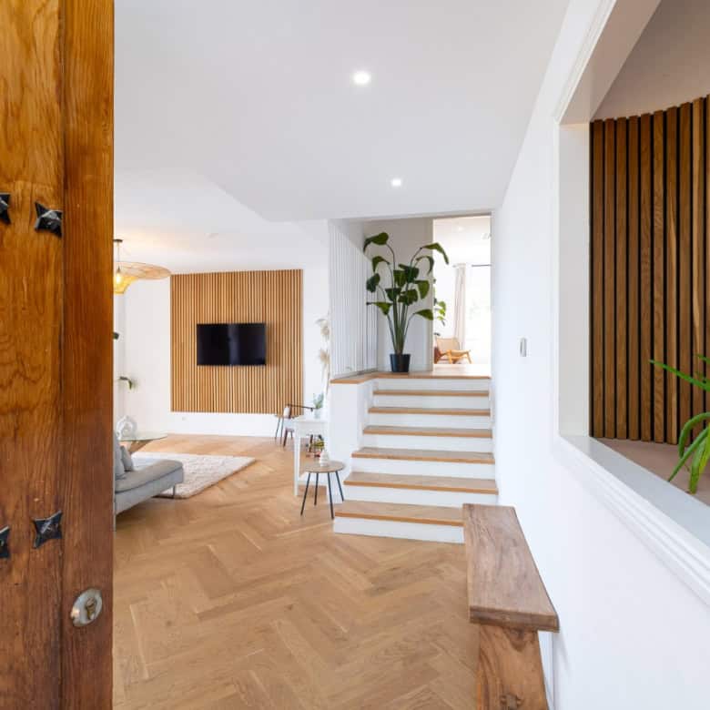 Bright, modern penthouse interior with panoramic south-facing views and stylish wooden accents.