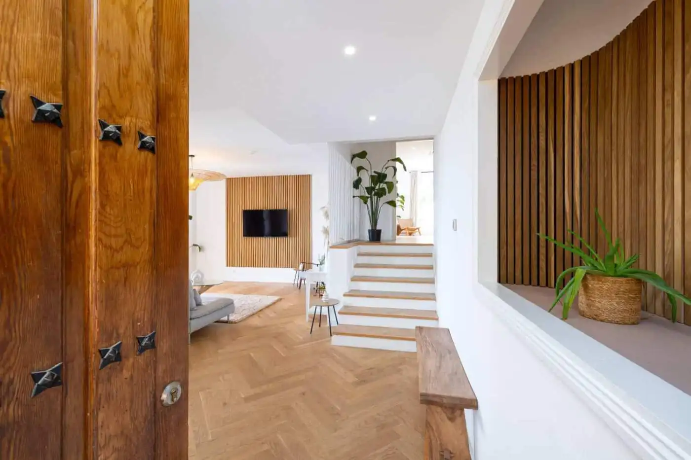 Bright, modern penthouse interior with panoramic south-facing views and stylish wooden accents.