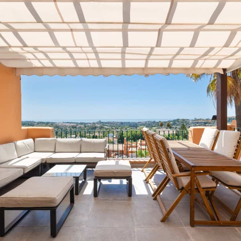Luxurious penthouse with south-facing panoramic city views and stylish outdoor seating area.