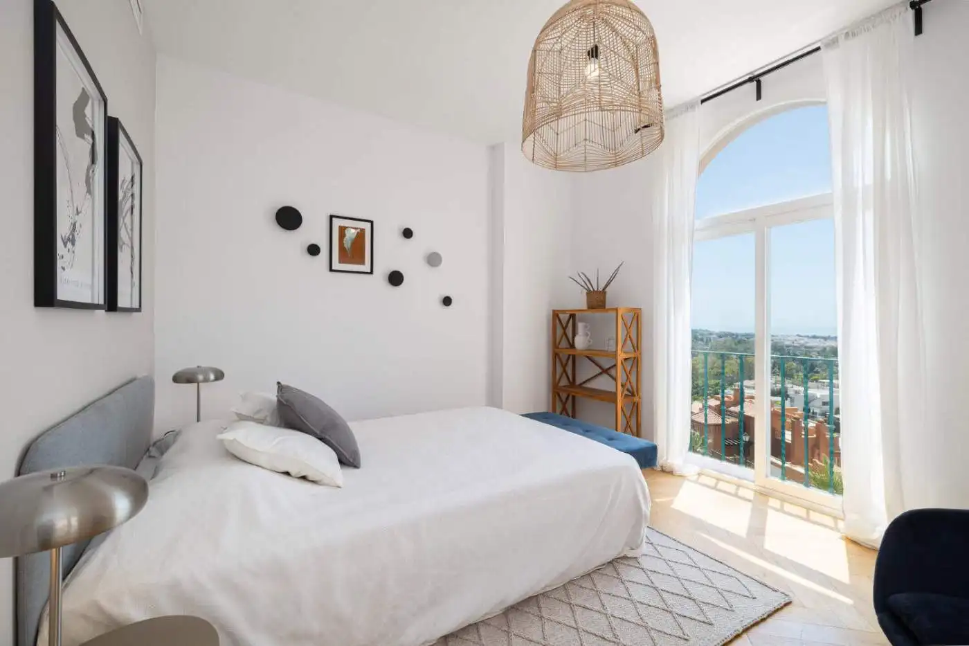 Penthouse bedroom with large window and city views.