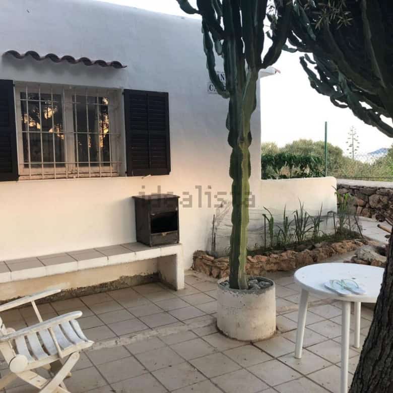 Villa estate with two houses for sale in Playa Den Bossa Ibiza Spain, featuring outdoor seating and.