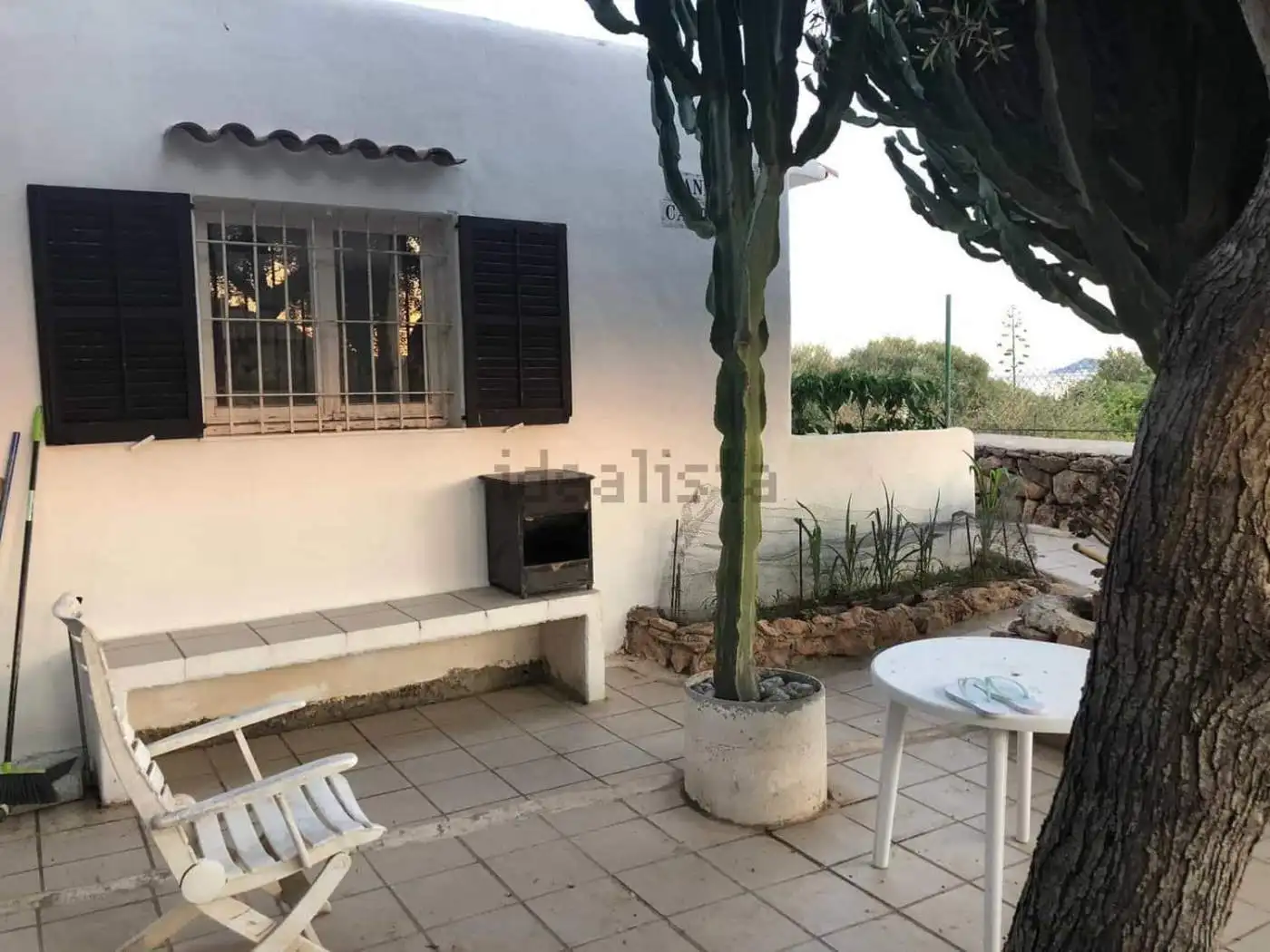 Villa estate with two houses for sale in Playa Den Bossa Ibiza Spain, featuring outdoor seating and.
