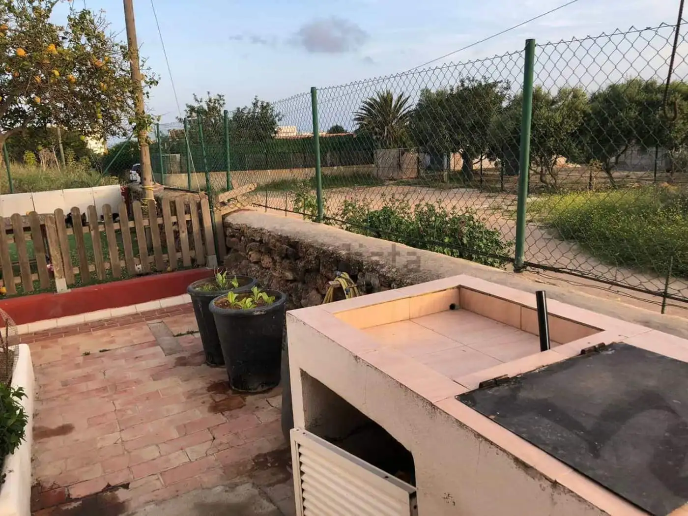Spacious outdoor terrace of villa estate with two houses in Playa Den Bossa Ibiza, ideal for relaxin.