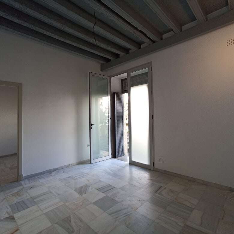Bright living room with large glass doors in El Puerto de Santa María, Cadiz. Perfect for comfortabl.