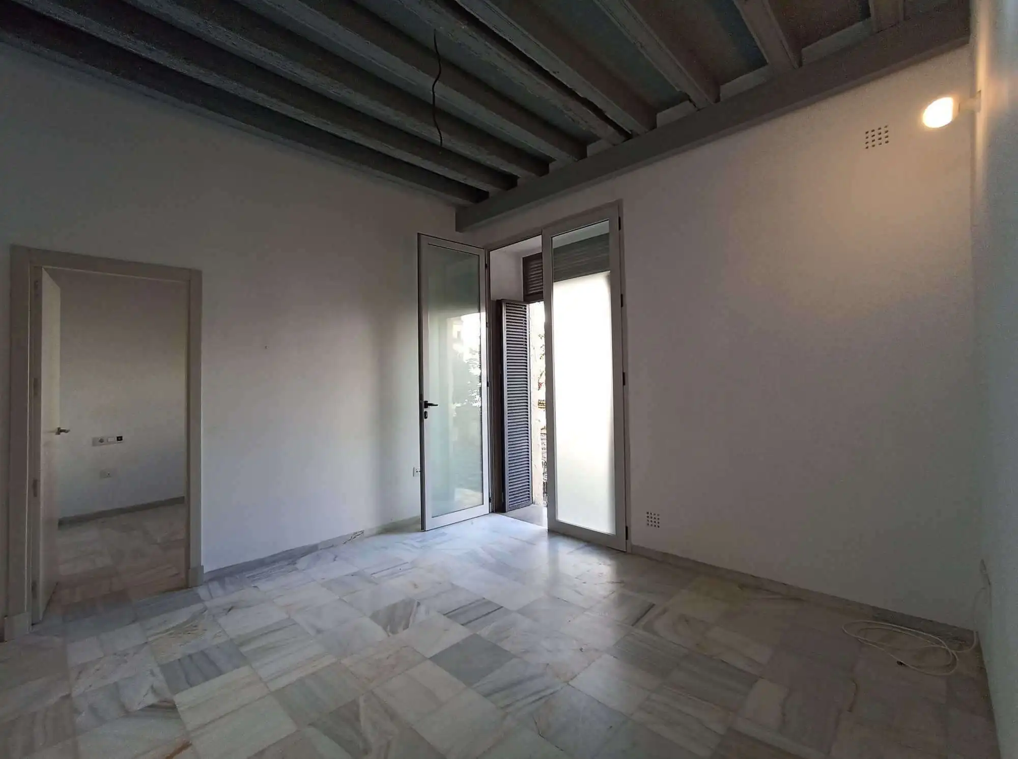 Bright living room with large glass doors in El Puerto de Santa María, Cadiz. Perfect for comfortabl.