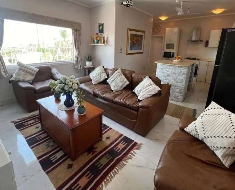 Spacious living room with comfortable sofas, modern decor, and natural light in Derrymore County Cla.