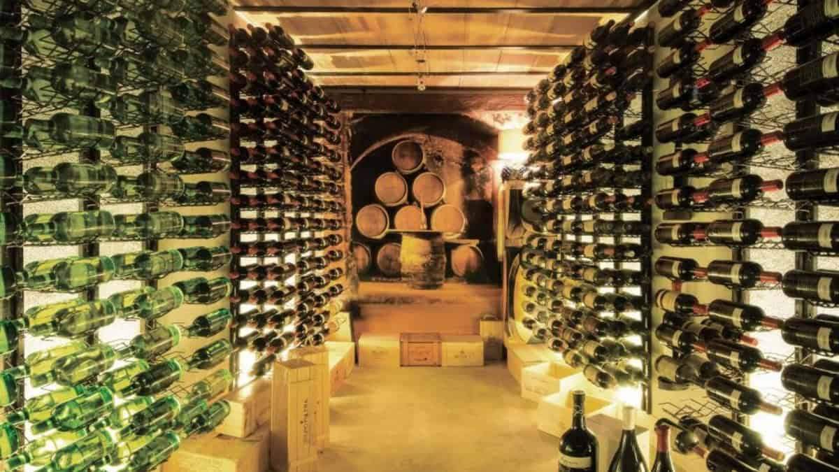 Luxurious wine cellar with wooden racks filled with wine bottles in Marbella apartment.