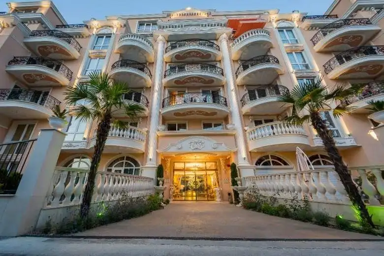Elegant Venera Palace building with balconies and lush landscaping in Sunny Beach.