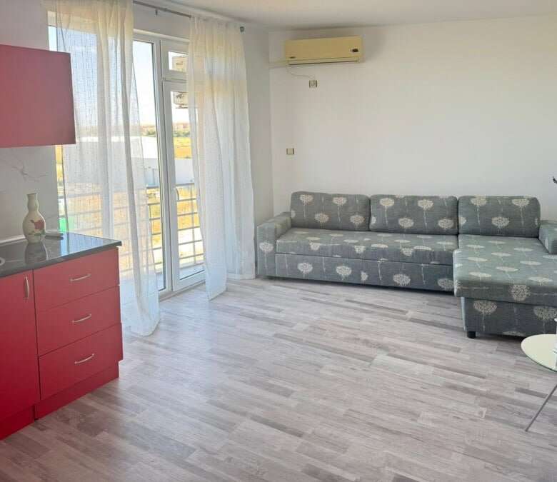 Bright living room with sofa and balcony access in Sunny Day 5.