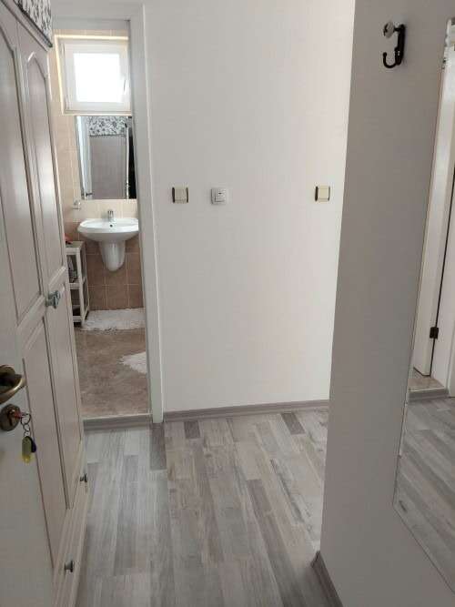 Interior view of a modern furnished apartment in Sunny Day 5, near bathroom.