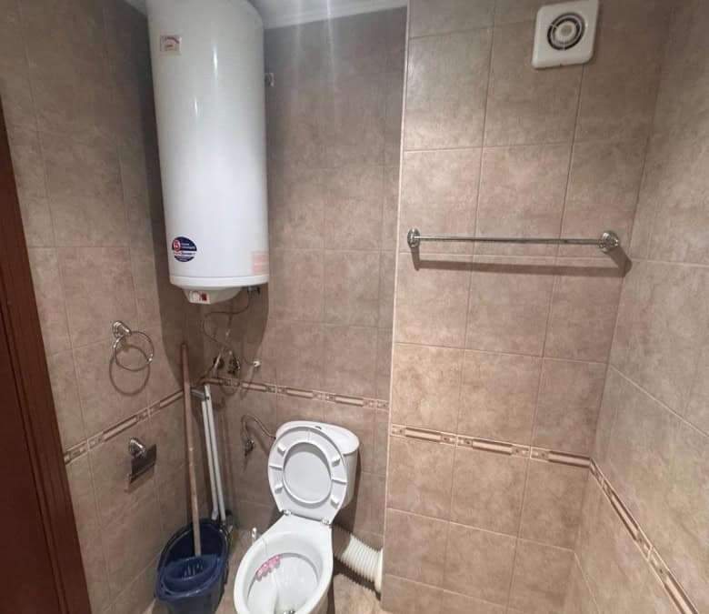 Bright bathroom with water heater and modern fixtures.