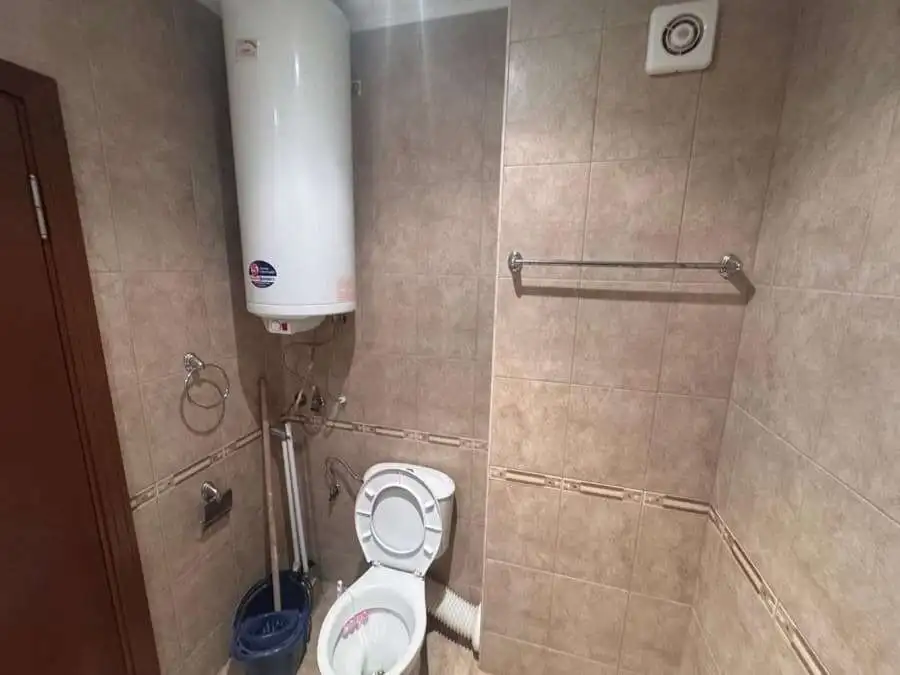 Bright bathroom with water heater and modern fixtures.