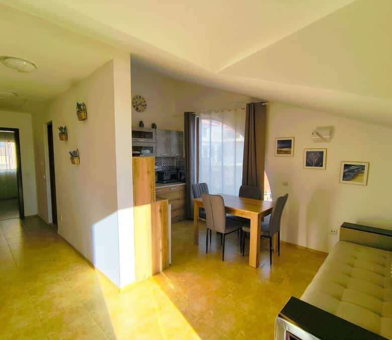 Bright interior of a 1-bedroom apartment near the sea in Sveti Vlas, featuring a dining area and com.