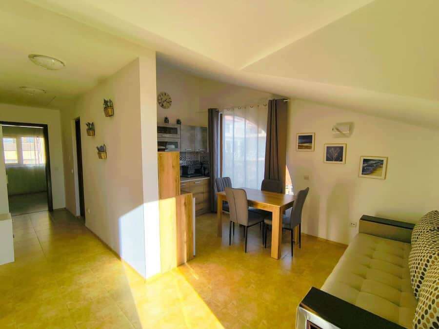 Bright interior of a 1-bedroom apartment near the sea in Sveti Vlas, featuring a dining area and com.