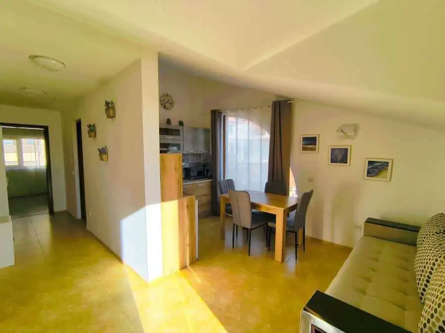 Bright interior of a 1-bedroom apartment near the sea in Sveti Vlas, featuring a dining area and com.