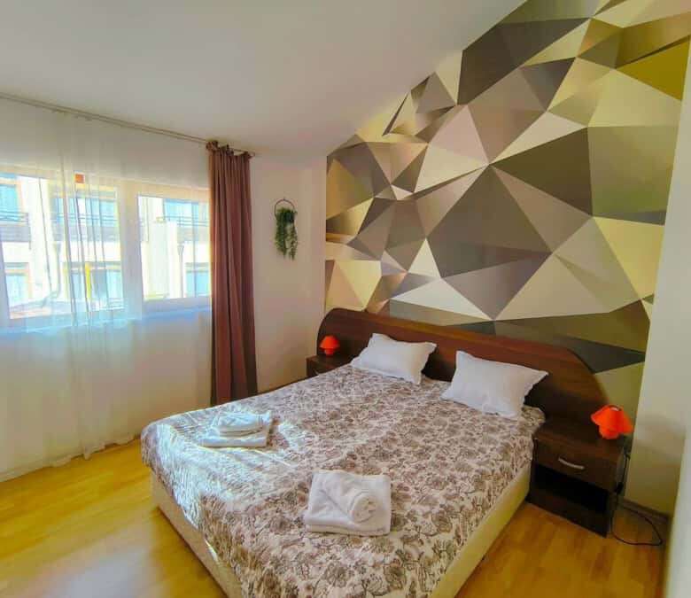 Bright bedroom with large window and modern decor in Sveti Vlas.