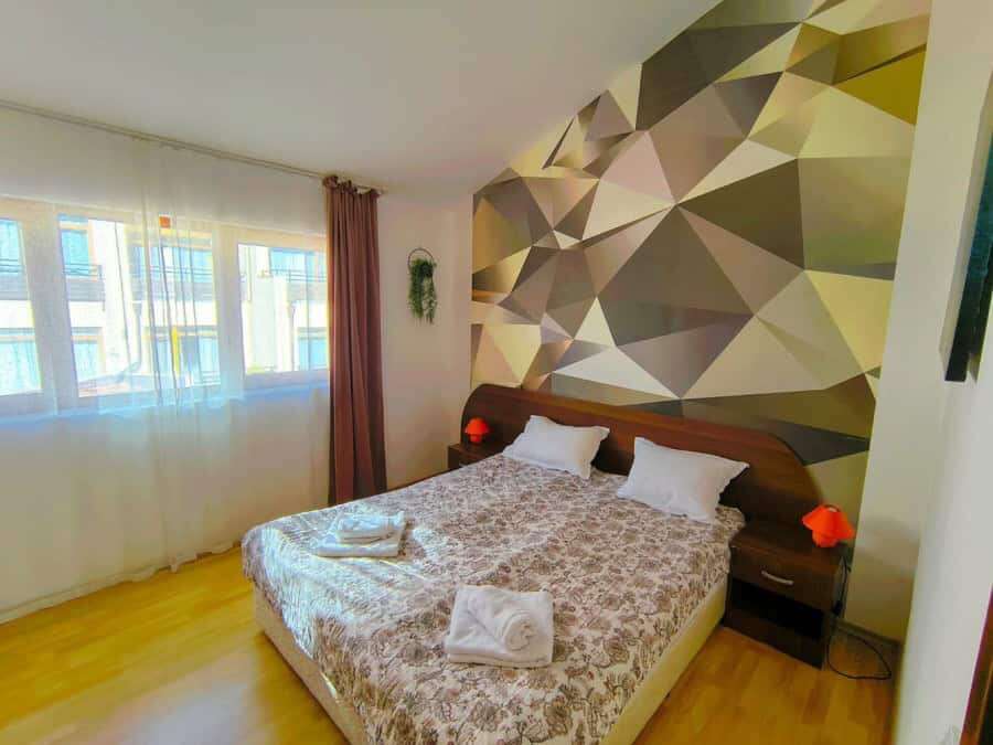 Bright bedroom with large window and modern decor in Sveti Vlas.