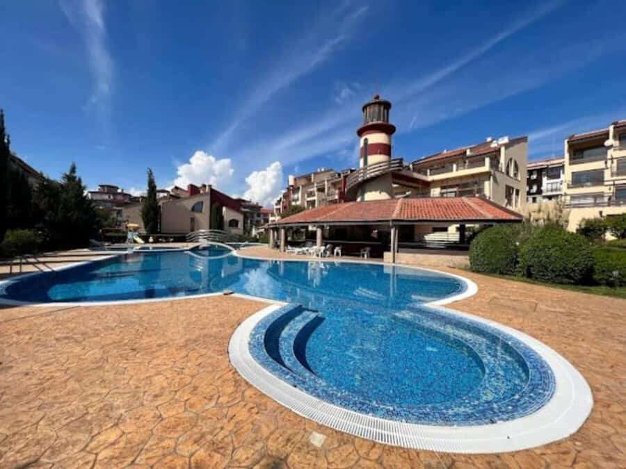 Swimming pool at Sea Lighthouse in Sveti Vlas, close to the sea, featuring a unique lighthouse backd.
