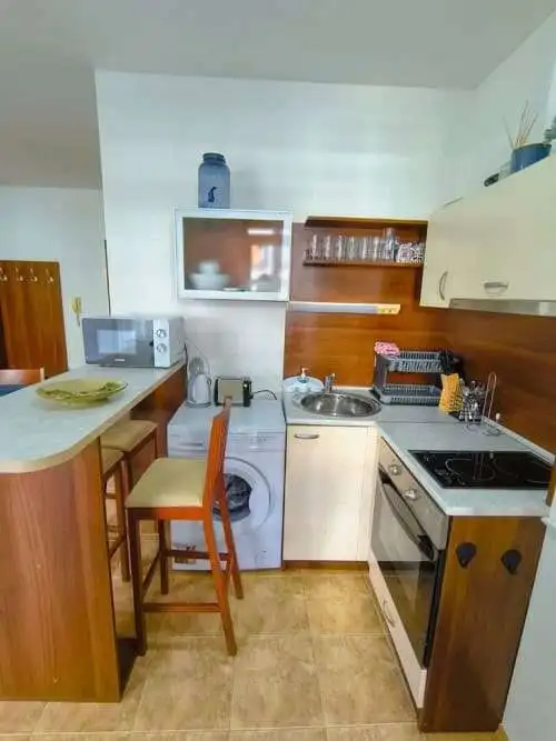 Compact kitchen in a seaside studio apartment.