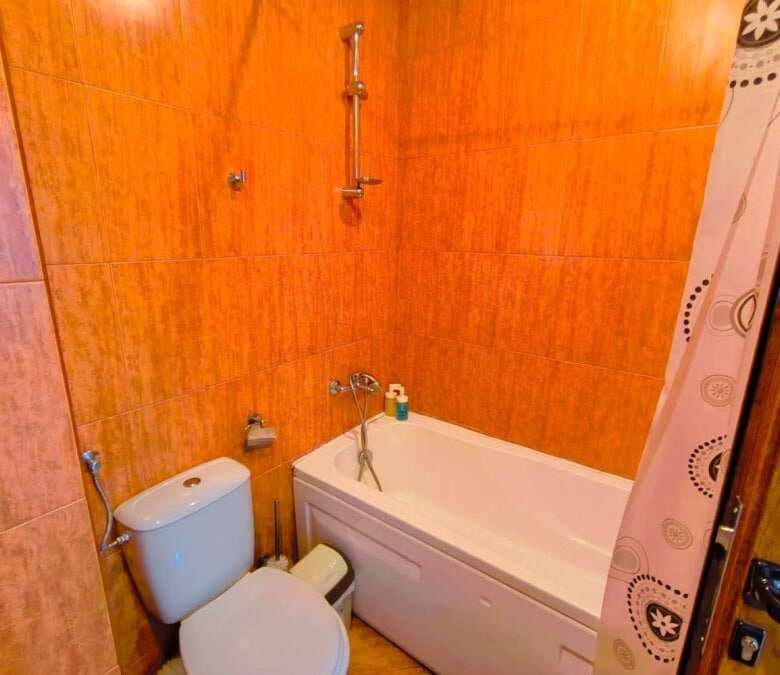Modern bathroom with bathtub in a spacious studio apartment near the sea.