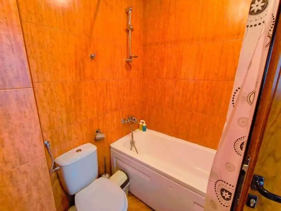 Modern bathroom with bathtub in a spacious studio apartment near the sea.