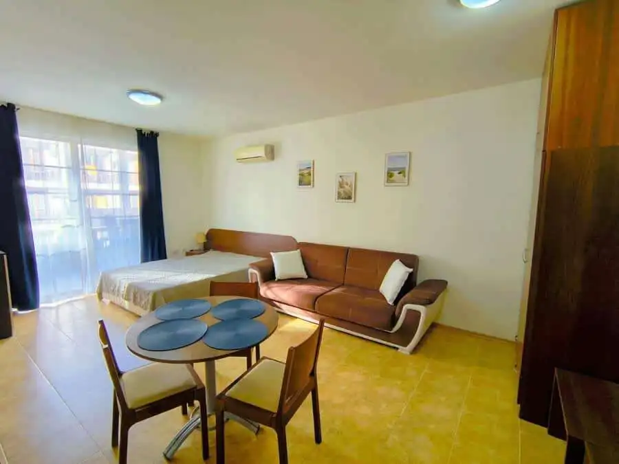 Bright studio apartment near the sea in Sveti Vlas, featuring a living area, dining space, and moder.