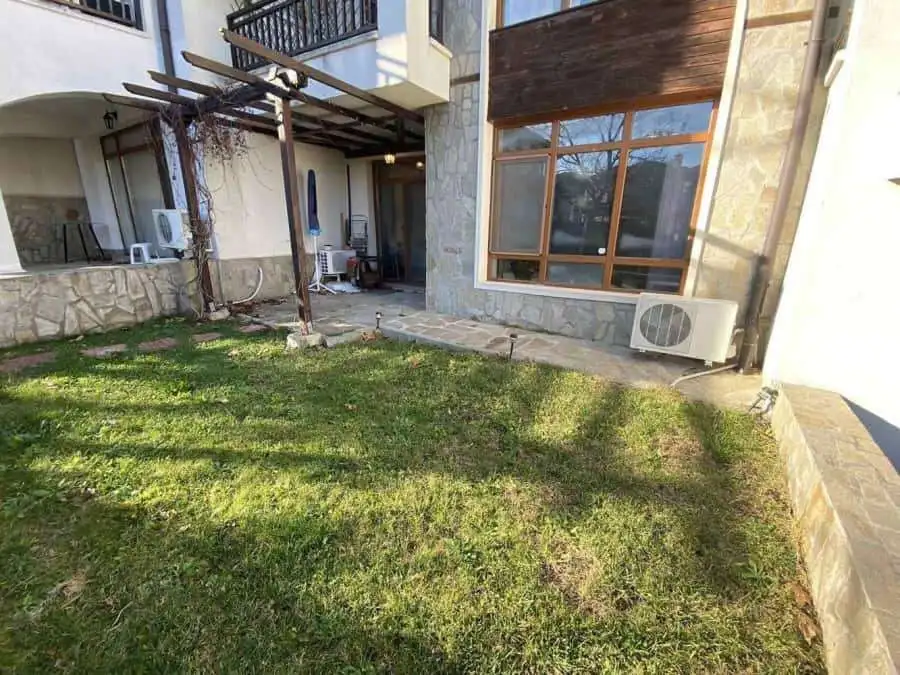 Bright outdoor garden space of a 1-bedroom apartment near the sea.