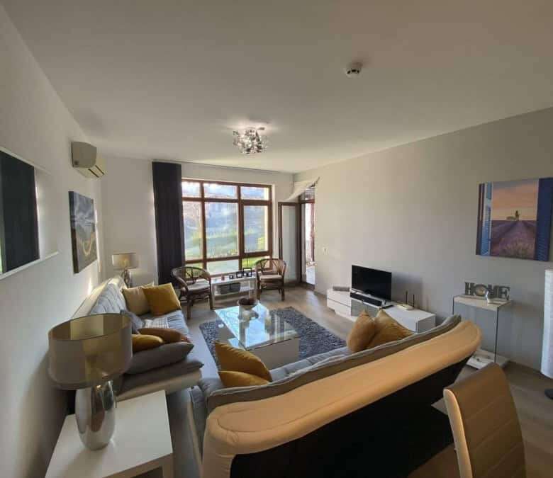 Bright living room with large windows and stylish furniture.