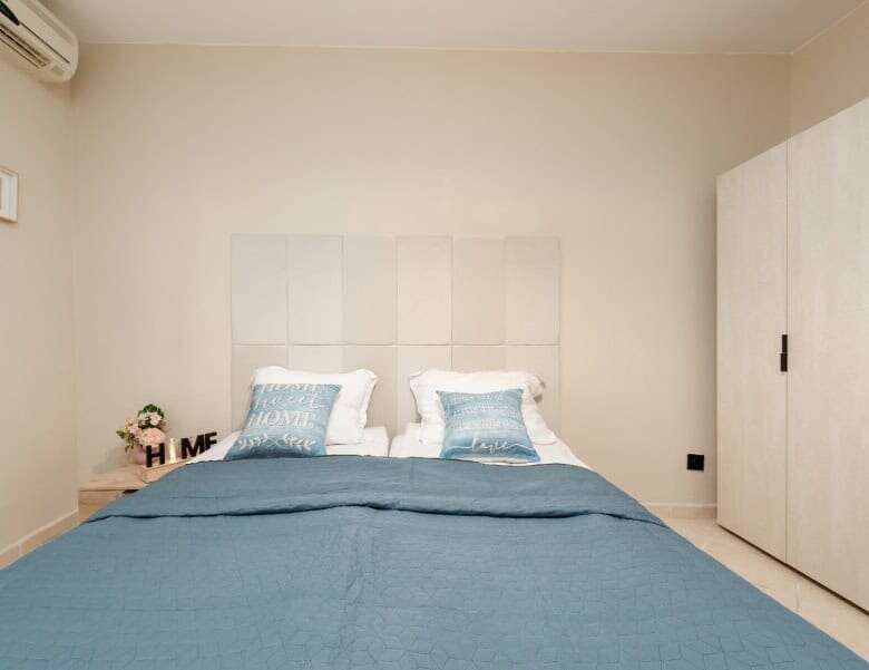 Bright bedroom with pool view in Sunny Beach, Bulgaria, featuring a comfortable bed and modern decor.