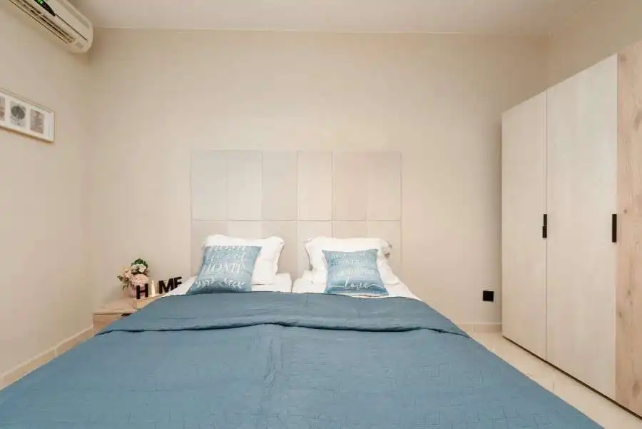 Bright bedroom with pool view in Sunny Beach, Bulgaria, featuring a comfortable bed and modern decor.